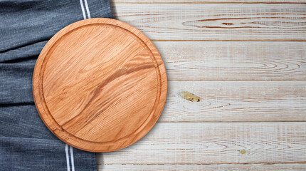 Pizza board with napkin on wooden table. Top view mockup
