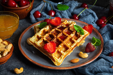 Delicious breakfast with belgian waffles. Waffels with strawberry and berry jam