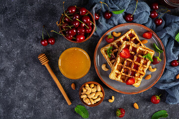 Delicious breakfast with belgian waffles. Waffels with strawberry and berry jam