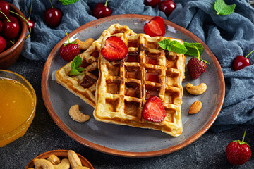 Delicious breakfast with belgian waffles. Waffels with strawberry and berry jam
