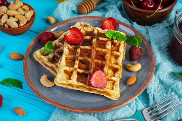Delicious breakfast with belgian waffles. Waffels with strawberry and berry jam