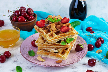 Delicious breakfast with belgian waffles. Waffels with strawberry and berry jam