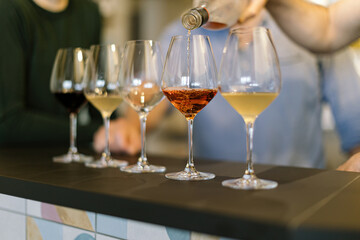 pouring wine on glasses - preparing wine tasting