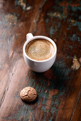 Cup of coffee with Amaretti (Italian biscuit) on rustic wooden background. Copy space.                                                                                                                 