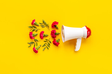 Good news or advertising concept with megaphote and flying flowers