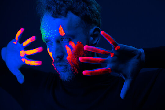 Caucasian male model with blacklight paint.