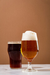 Two glasses with light and dark beer beverages