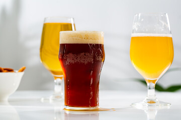 A few glasses with light dark craft beer on table