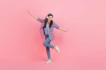 Full length photo of cheerful charming female dancing visit disco club wear headset isolated on pink color background