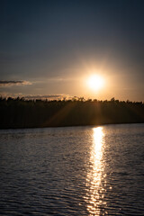 Sunset at the lake in the middle of a forest in Poland