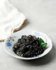 Stir Fried Squid and Chili in Black Sauce or Cumi Hitam  Served in Ceramic Plate.