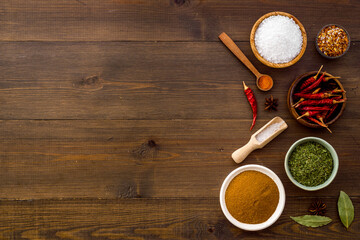 Cooking ingredients - colorful spices and herbs in bowls, top view