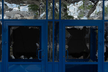 Consequences of a bombed building window, broken glass, building damage, destruction, war, Ukraine,...