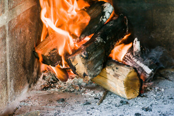 Burning wood logs in home kitchen.
