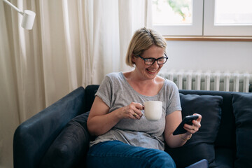 adult woman reading messages on smartphone