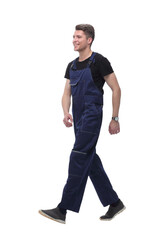 smiling man in overalls goes forward.isolated on white