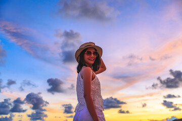 Traveler asian woman travel on Phuket beach in sunset Thailand