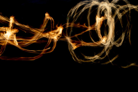 Circles of fire. Lines of flame. Shooting fire show on long shutter speed.