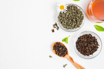Varieties of premium black or red and green tea , Chinese oolong tea with ginseng, brewed tea in cup. Assortment of tea in shop. White background. Top view