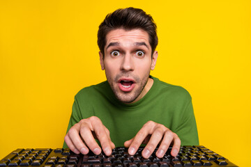 Portrait of attractive funny stunned guy nerd writing text staring isolated over vibrant yellow...