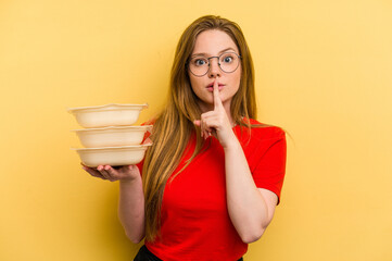 Young caucasian woman holding tupper isolated on yellow background keeping a secret or asking for silence.