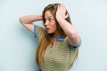 Young caucasian woman isolated on blue background screaming, very excited, passionate, satisfied with something.