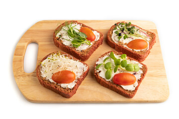 Red beet bread sandwiches with cream cheese, tomatoes and microgreen isolated on white. side view.