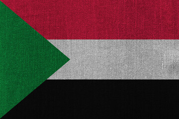 Patriotic classic denim background in colors of national flag. Sudan