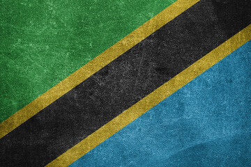 Old leather shabby background in colors of national flag. Tanzania