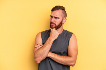 Young caucasian man isolated on yellow background suffers pain in throat due a virus or infection.