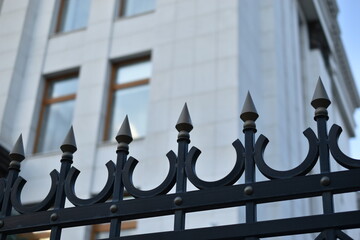 The iron fence of the government building in the park Russia. Iron pins on the fence.