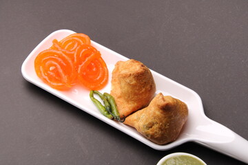 samosa and jalebi or jilebi served with red and green chutney