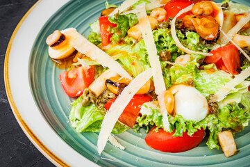 fresh tasty salad with seafood on a black background