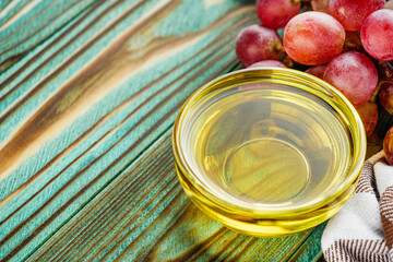 grape seed essential oil on a wooden rustic background