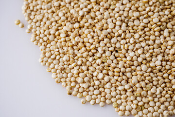 white quinoa seeds on a white acrylic background
