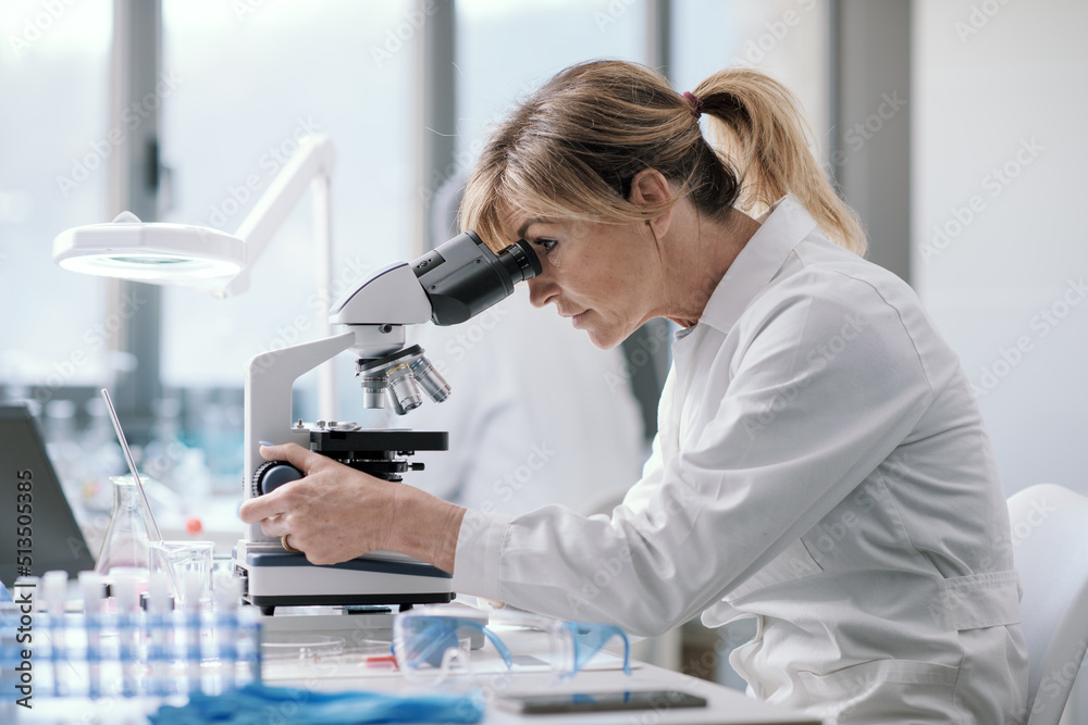 Wall mural professional scientist using a microscope