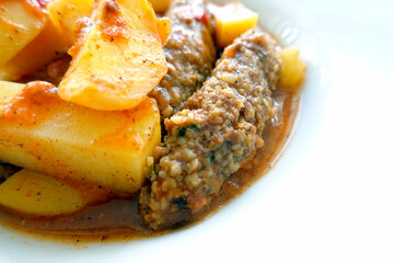 Juicy Meatballs. Meatballs with tomato and patatoes in white plate isolated. Traditional turkish meat dish.