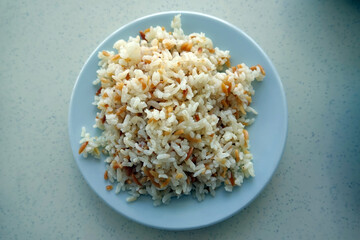 Close up of a plate of Turkish Pilaf - Pilav white plate, background. Turkish traditional meal.         