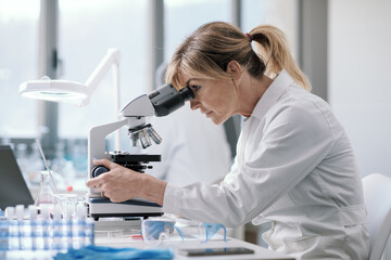 Professional scientist using a microscope