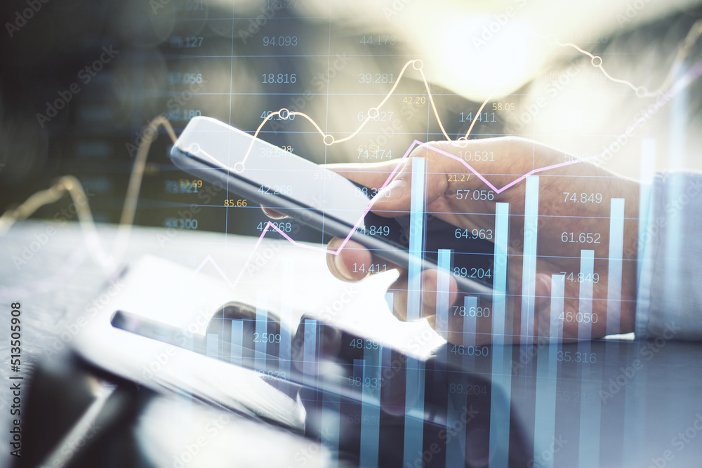 Poster businessman hand using smartphone and tablet at desktop with abstract glowing business chart with in