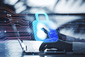 Close up of hands using laptop keyboard with glowing padlock hologram and lines on blurry outdoor background. Secure, safety and protection concept. Double exposure.