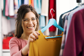 Woman choosing clothes on a rack