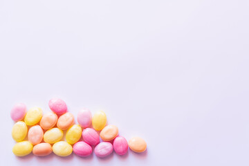 Top view of colorful sweets on white background with copy space.