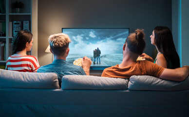 Friends watching movies together at home