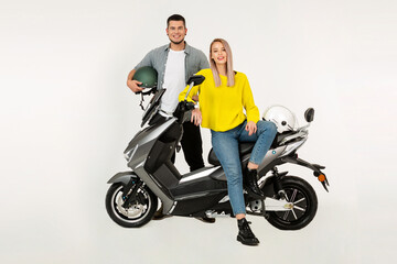 Fototapeta na wymiar young attractive couple riding an electric motorbike scooter happy having fun together