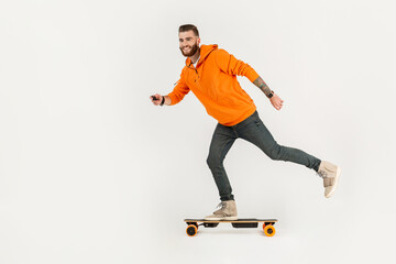 young hipster style man skateboarding on electric skateboard