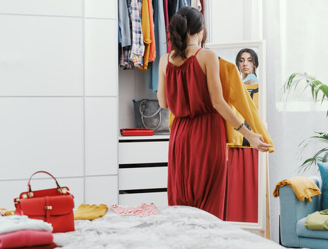 Woman choosing clothes in her bedroom