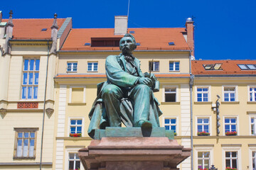 Fototapeta na wymiar Old Statue of the Polish poet, playwright and comedy writer Aleksander Fredro on the Market Square in front of the Town Hall of Wroclaw, Poland 