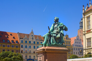 Old Statue of the Polish poet, playwright and comedy writer Aleksander Fredro on the Market Square in front of the Town Hall of Wroclaw, Poland - obrazy, fototapety, plakaty
