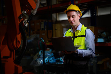 A male engineer checking the operation of a welding robot. used for precision welding control Fast and highly secure